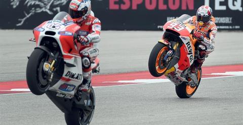 Andrea Dovizioso (Ducati) hace un caballito por delante del español Marc Marquez (Repsol Honda) en el Circuito de las Americas de Austin, Texas, (USA). EFE