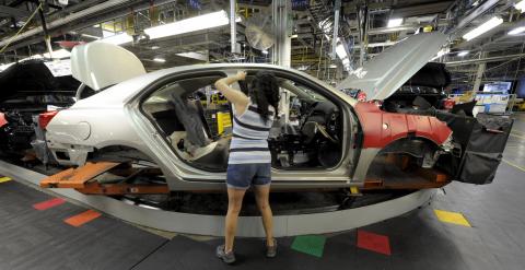 Auto worker Linda Martinez installs a part on a 2015 Chevrolet Malibu being built at GM's Fairfax assembly plant in Kansas City Kansas May 4, 2015. REUTERS/Dave Kaup