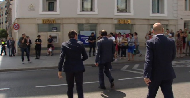 Mariano Rajoy cruzando este martes apresuradamente la Carrera de San Jerónimo en Madrid por una zona por la que no debía junto al portavoz del PP en el Congreso, Rafael Hernando. PUBLICO