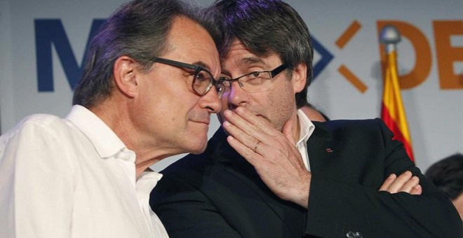 El presidente de la Generalitat, Carles Puigdemont (d), conversa con el líder de CDC, Artur Mas (i), en la sede electoral de CDC en la noche del 26J. /EFE