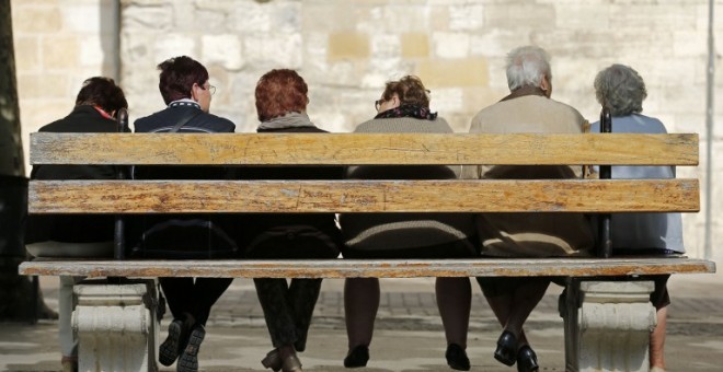 Varios ancianos sentandos en un banco en el pueblo burgalés de Bribiesca. AFP