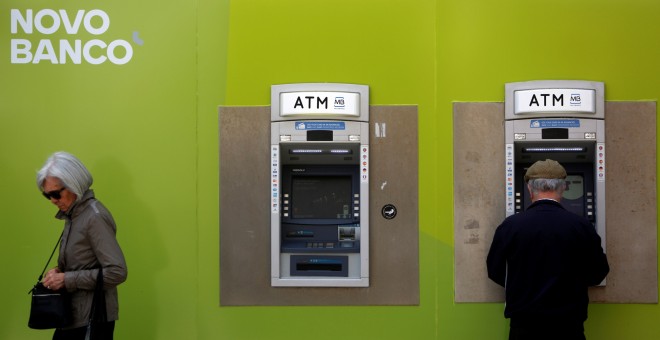 Dos ciudadanos pasan delante de una oficina de Novo Banco en Lisboa, Portugal.REUTERS/Pedro Nunes