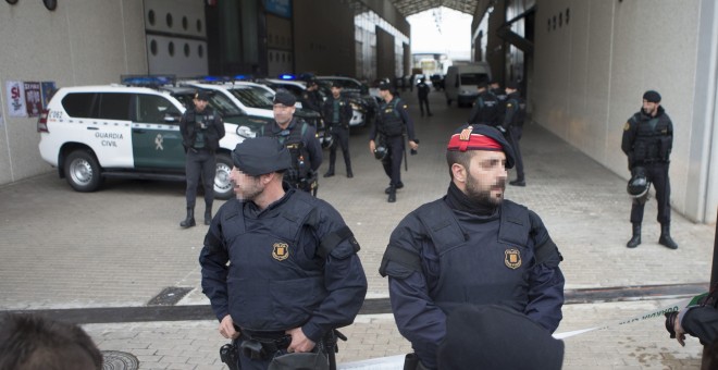 Mossos d'Esquadra junto a los agentes de la Guardia Civil que han entrado en la imprenta Artyplan de Sant Feliu de Llobregat (Barcelona) en el marco de los registros que está realizando en busca de material relacionado con el referéndum del 1 de octubre.