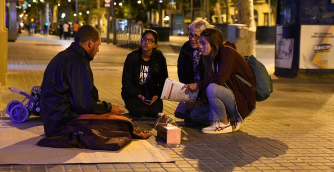 Voluntaris d'Arrels amb una persona sense llar. ARRELS FUNDACIÓ