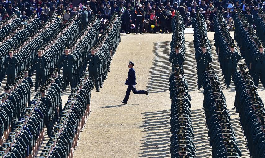 Un nuevo recluta de Corea del Sur corre a su puesto durante su ceremonia de graduación. / AFP