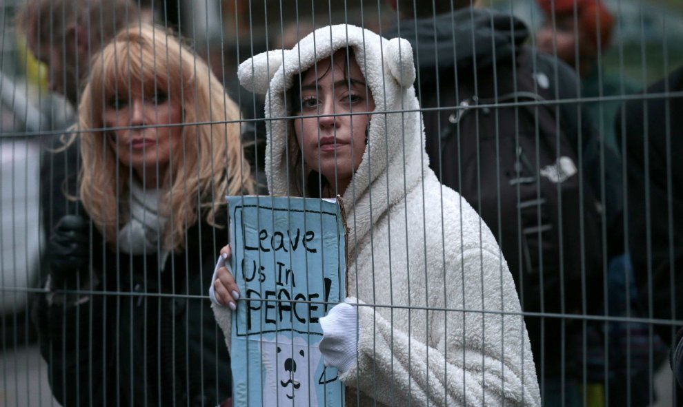 Una manifestante con un traje de oso polar sujeta una pancarta que dice "Dejadnos vivir en paz" en Londres. REUTERS/Suzanne Plunkett