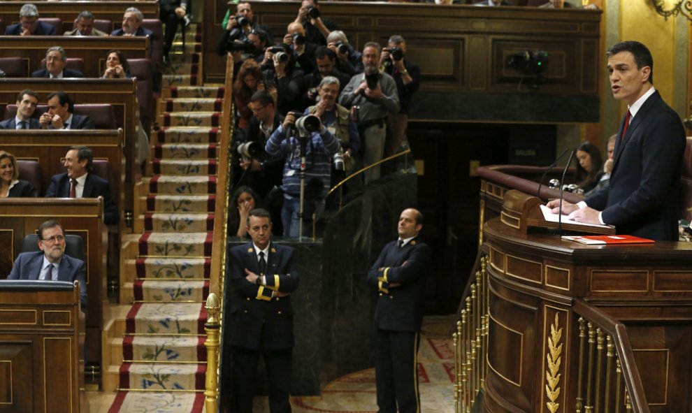 El presidente del Gobierno en funciones, Mariano Rajoy (i), escucha la intervención del secretario general del PSOE, Pedro Sánchez (d), durante la primera jornada de la sesión de investidura esta tarde en el Congreso de los Diputados. EFE/J. J. Guillén