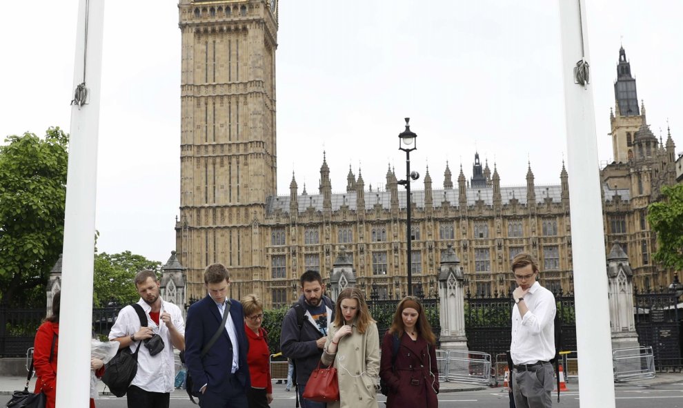 Varias personas frente al Parlamento de Londres llorando la pérdida de la diputada