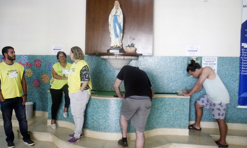 BELO HORIZONTE (BRASIL), 28/10/2018.- Ciudadanos esperan para votar hoy, domingo 28 de octubre de 2018, en una zona electoral en la ciudad de Belo Horizonte, en el estado de Minas Gerais (Brasil). Los colegios electorales de Brasil abrieron hoy para la se