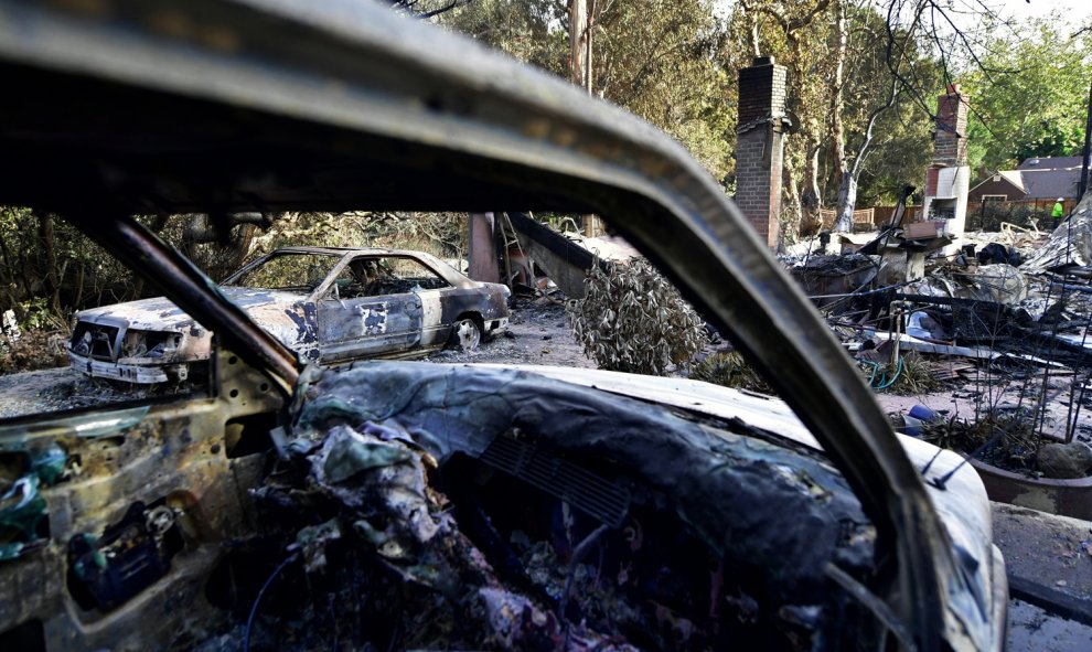 Vehículos calcinados yacen en mitad de la carretera en las inmediaciones de Filaree Heights Road, Malibu.- AFP