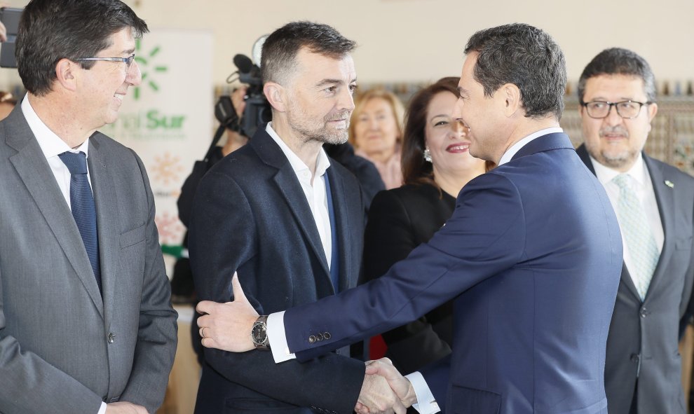 El presidente electo de la Junta de Andalucía, Juanma Moreno, saluda al líder de IU, Antonio Maíllo, en presencia del líder de Ciudadanos, Juan Marín (i), y del portavoz de Vox, Francisco Guerero, a su llegada al Parlamento en Sevilla para el acto de toma