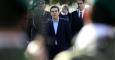 Greek Prime Minister Alexis Tsipras reviews an honor guard during his visit the Cyprus military cemetery on the outskirts of the capital Nicosia, Tuesday, Feb. 3, 2015. AP