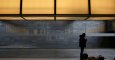 Un hombre debajo del logo de Telefonica, en la sede de la compañía en el distrito de Las Tablas, en el norte de Madrid. REUTERS/Juan Medina