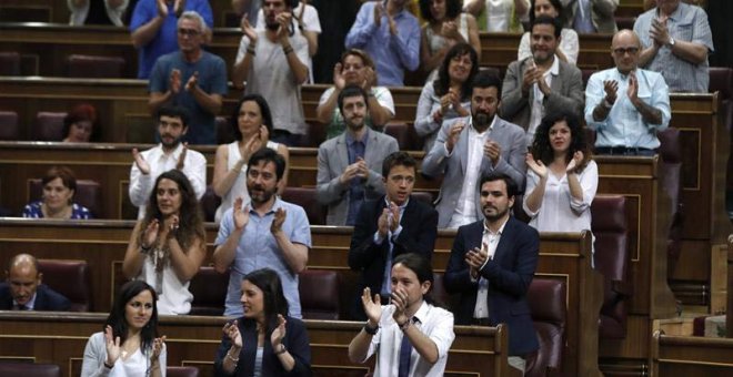 Los diputados de Podemos aplauden a uno de los suyos. | EFE