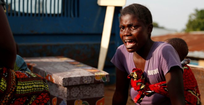 A woman cries during the funeral of a child, suspected of dying from Ebola, next to the coffin in Beni, North Kivu Province of Democratic Republic of Congo, December 17, 2018. REUTERS/Goran Tomasevic/File Photo