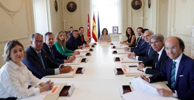 , 20/08/2019.- La presidenta de la Comunidad de Madrid, Isabel Díaz Ayuso (fondo), durante la primera reunión del nuevo Ejecutivo autonómico de coalición del PP y Ciudadanos tras la toma de posesión de los consejeros, este martes en la sede de la Presiden