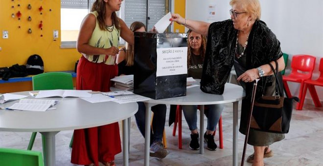 Una mujer deposita su voto en los comicios portugueses.  EFE/EPA/ANTONIO COTRIM