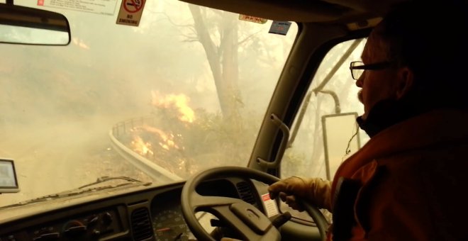 31/12/2019 - Los bomberos atraviesan las llamas durante la evacuación después de que los incendios se volvieran demasiado fuertes, Jenolan Caves, Nueva Gales del Sur, Australia. / JENOLAN CUEVAS (REUTERS)