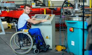 Trabajador en silla de ruedas en un taller. E.P.