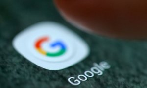 Un usuario de móvil pincha en un icono de Google en un teléfono móvil. (REUTERS)