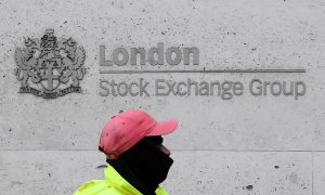 Un trabajador de la limpieza pasa por delante del edificio de la Bolsa de Londres (LSE, por sus siglas en inglés), en la City. REUTERS/Toby Melville