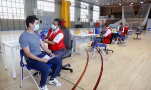 La Comunidad de Madrid comienza a vacunar contra el COVID-19 sin necesidad de cita previa en campus universitarios de la región. En la imagen, un joven recibe una dosis de la vacuna en el polideportivo de la Almudena de la Universidad Complutense (UCM), a