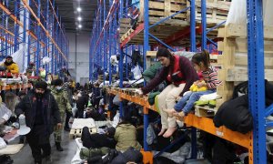 Refugiados y migrantes alojados en una nave cerca de Bruzgi (Bielorrusia), fronteriza con Polonia.