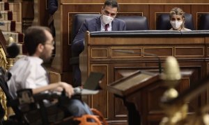 10/11/2021.- El presidente del Gobierno, Pedro Sánchez (c), y la vicepresidenta segunda del Gobierno y ministra de Trabajo, Yolanda Díaz, observan la intervención del portavoz de Unidas Podemos, Pablo Echenique, en una sesión plenaria en el Congreso de lo