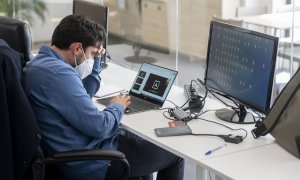 Un trabajador con mascarilla quirúrgica, el día en que ha entrado en vigor el decreto que pone fin al uso de la mascarilla en la mayoría de interiores, en la consultora de Marketing Alkemy, a 20 de abril de 2022, en Madrid (España).