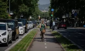 Una mujer circula montada en bicicleta en un carril bici de Barcelona en mayo de 2022.