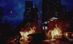 Manifestantes queman contenedores en París contra la reforma de la pensiones del presidente, Enmanuel Macron.