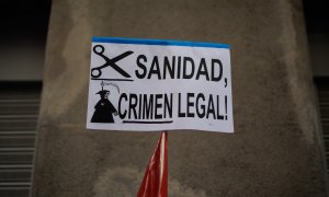 Una pancarta que reza 'Sanidad, Crimen Ilegal' durante una protesta de los trabajadores del servicio de atención telefónica de la centralita de atención de emergencias del Summa 112, que atiende el 061, frente a la Consejería de Sanidad, a 10 de marzo de