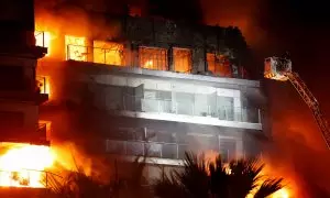 Firefighters work at the scene of a fire of apartment building in Valencia, Spain